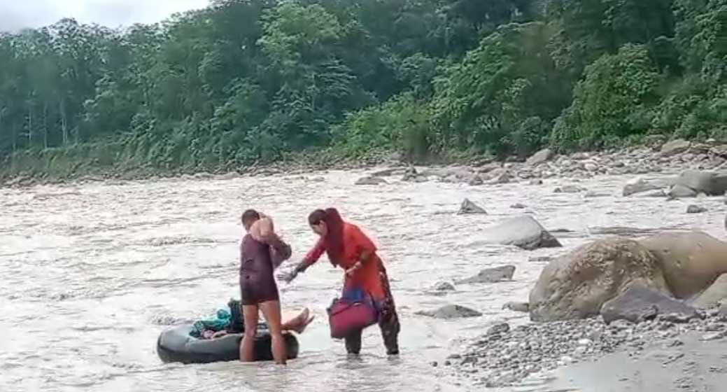 Villagers are crossing the river with the help of tube if the bridge is not built