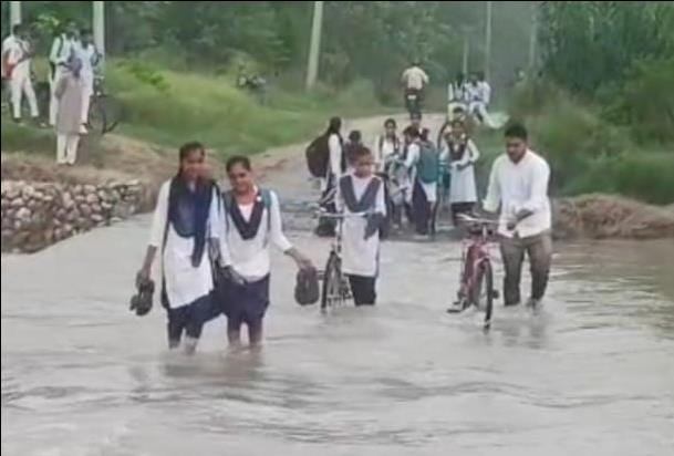 Students passing through the slippery waters risking their lives