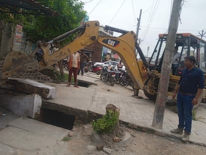 Paved construction in front of shops broken by JCB
