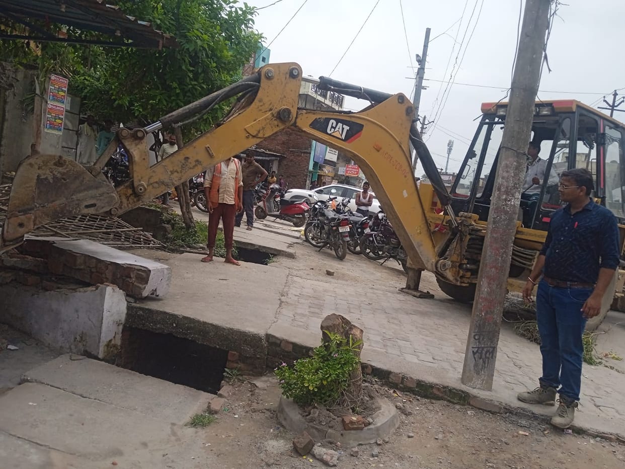 Paved construction in front of shops broken by JCB
