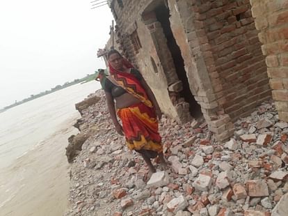 Villagers hammering on their own house