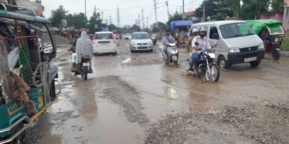 Mud and potholes made it difficult to walk on Delhi road