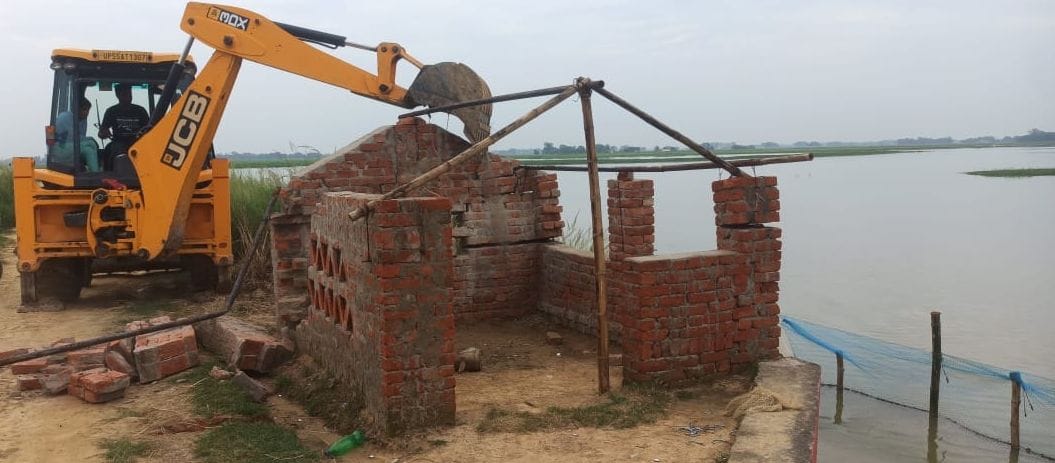 Bulldozers run on concrete bases built by encroachment on seas