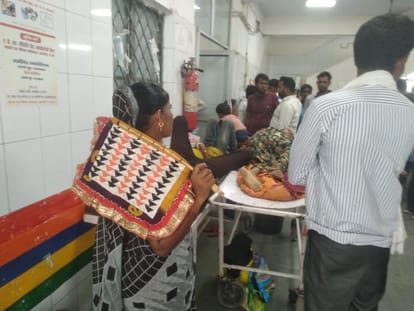 Line of patients in OPD, attendants fanning the trauma center