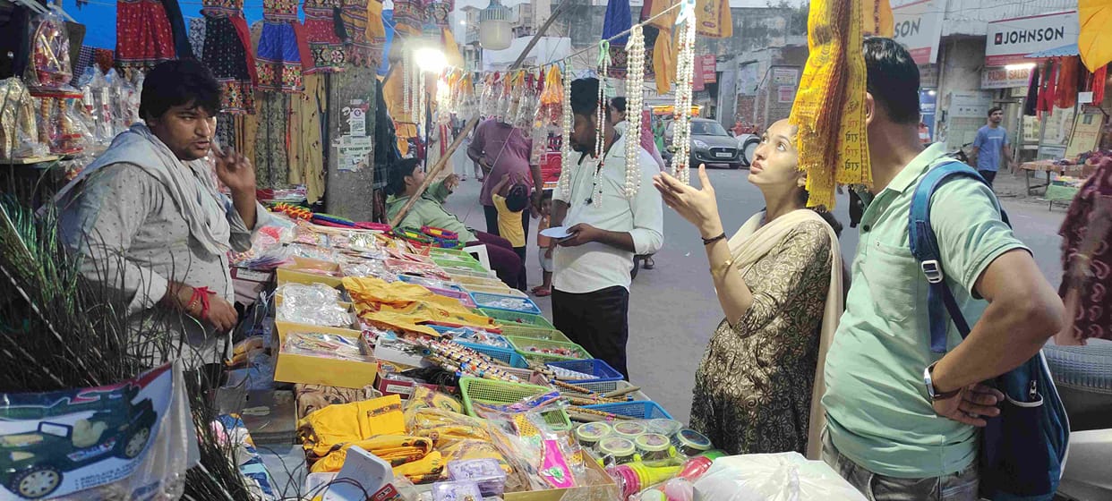 People engaged in shopping for Laddu Gopal