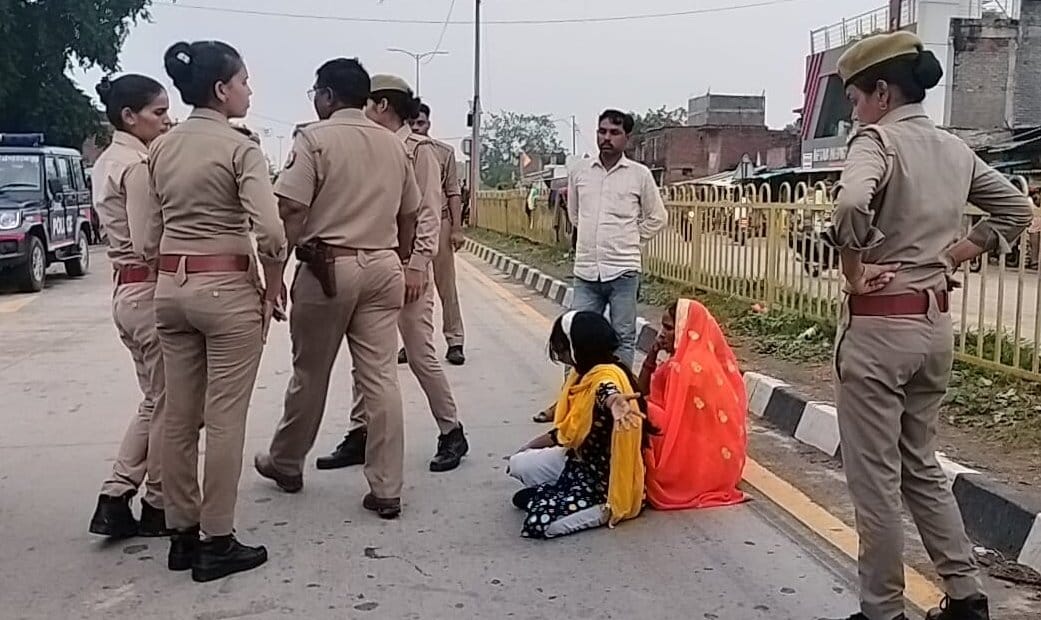 Teenager sitting on the road in protest against police, highway jammed