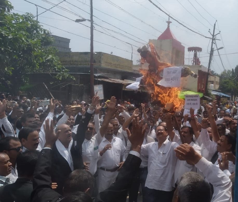 Advocates protest and burn effigy of government