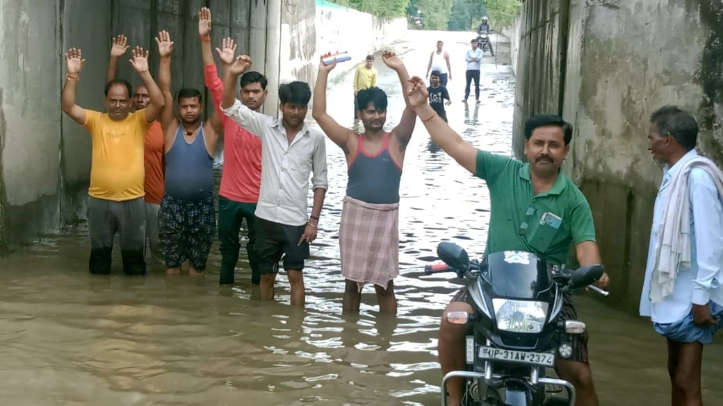 Villagers demonstrated by standing in water filled underpass