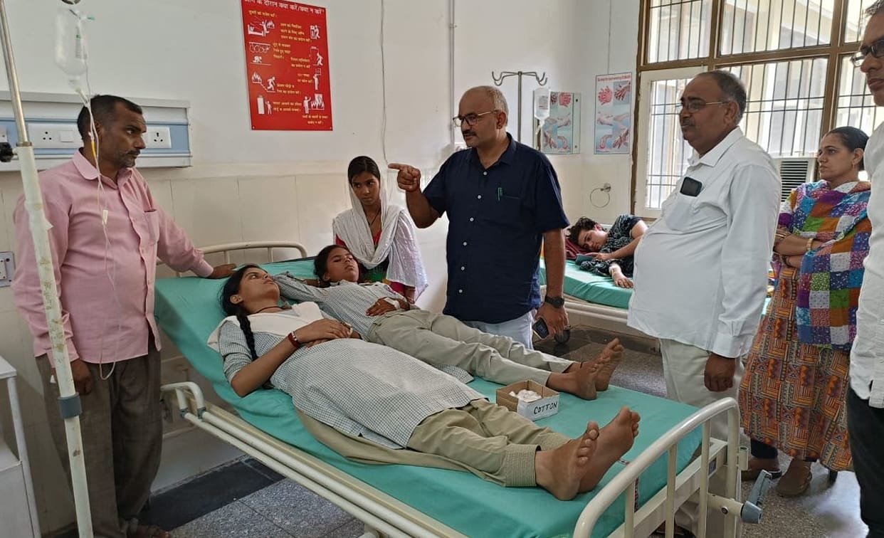 The health of 12 girl students suddenly deteriorated in the humid heat.