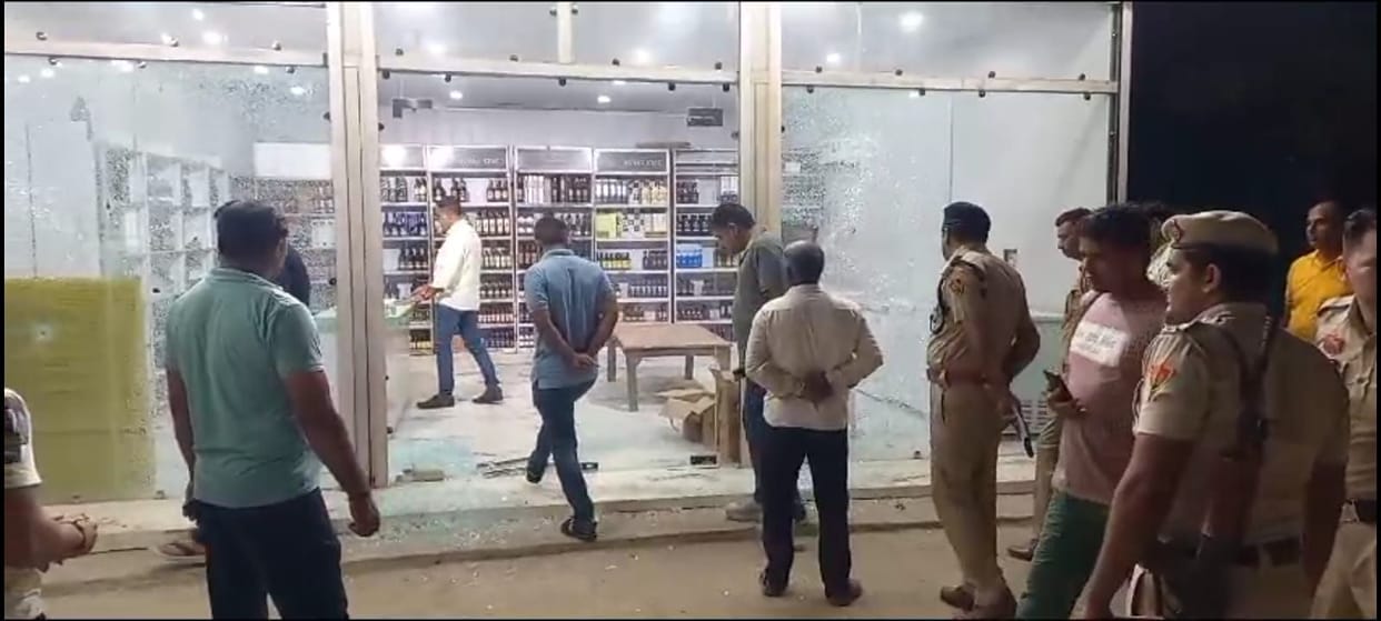 Entered the shop and picked up liquor, when stopped opened fire