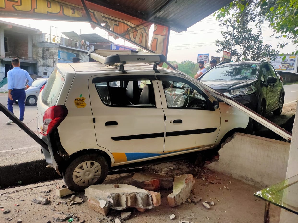 The car was hit by a car parked at Kohli Chowk, and reached the verandah of the shop.