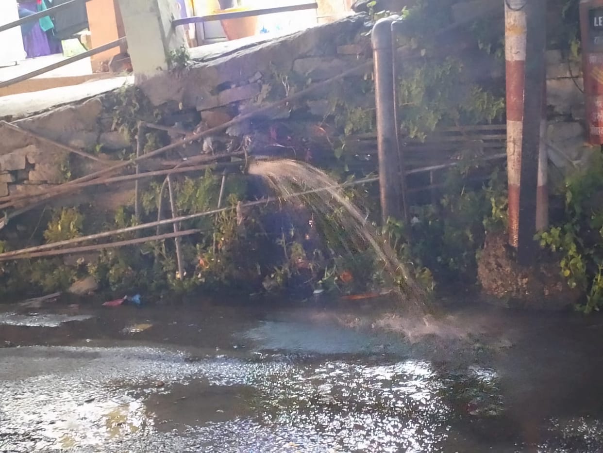 Water being wasted on the road in Almora