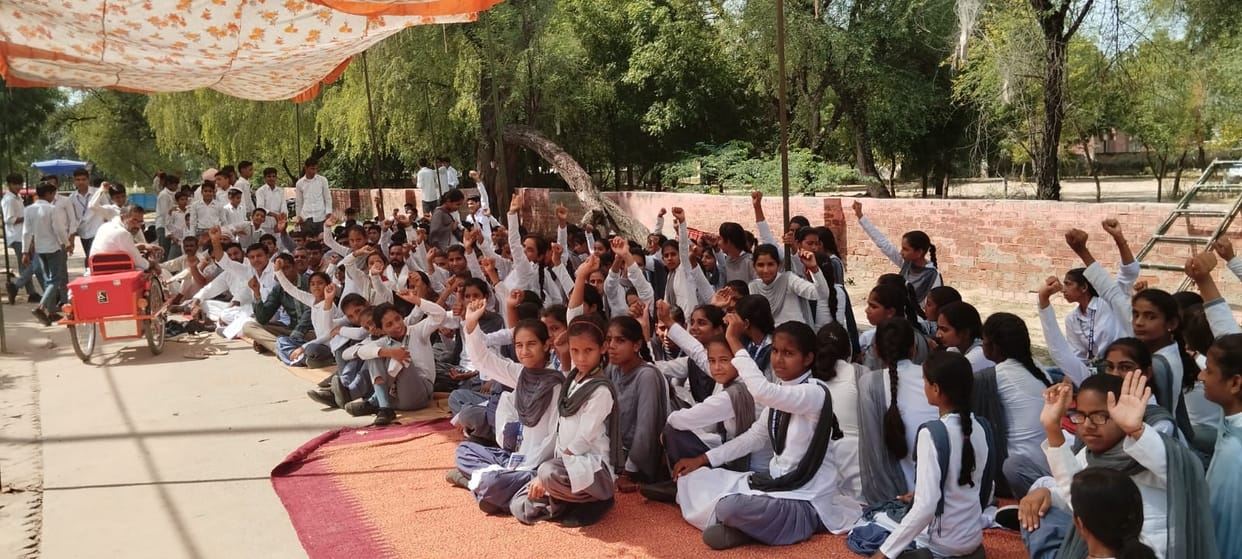 Angered by sending school staff on deputation, parents and villagers staged a protest