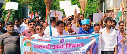 Sanitation workers demonstrated with brooms in their hands