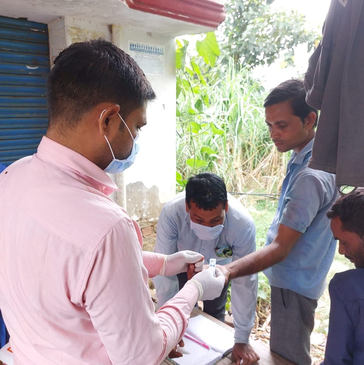 Health department team gathered in the village after the death of an elderly person