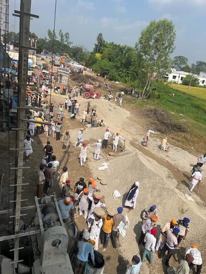 Sikh Sangat gathered to perform Kar Seva for the construction of Gurdwara building.