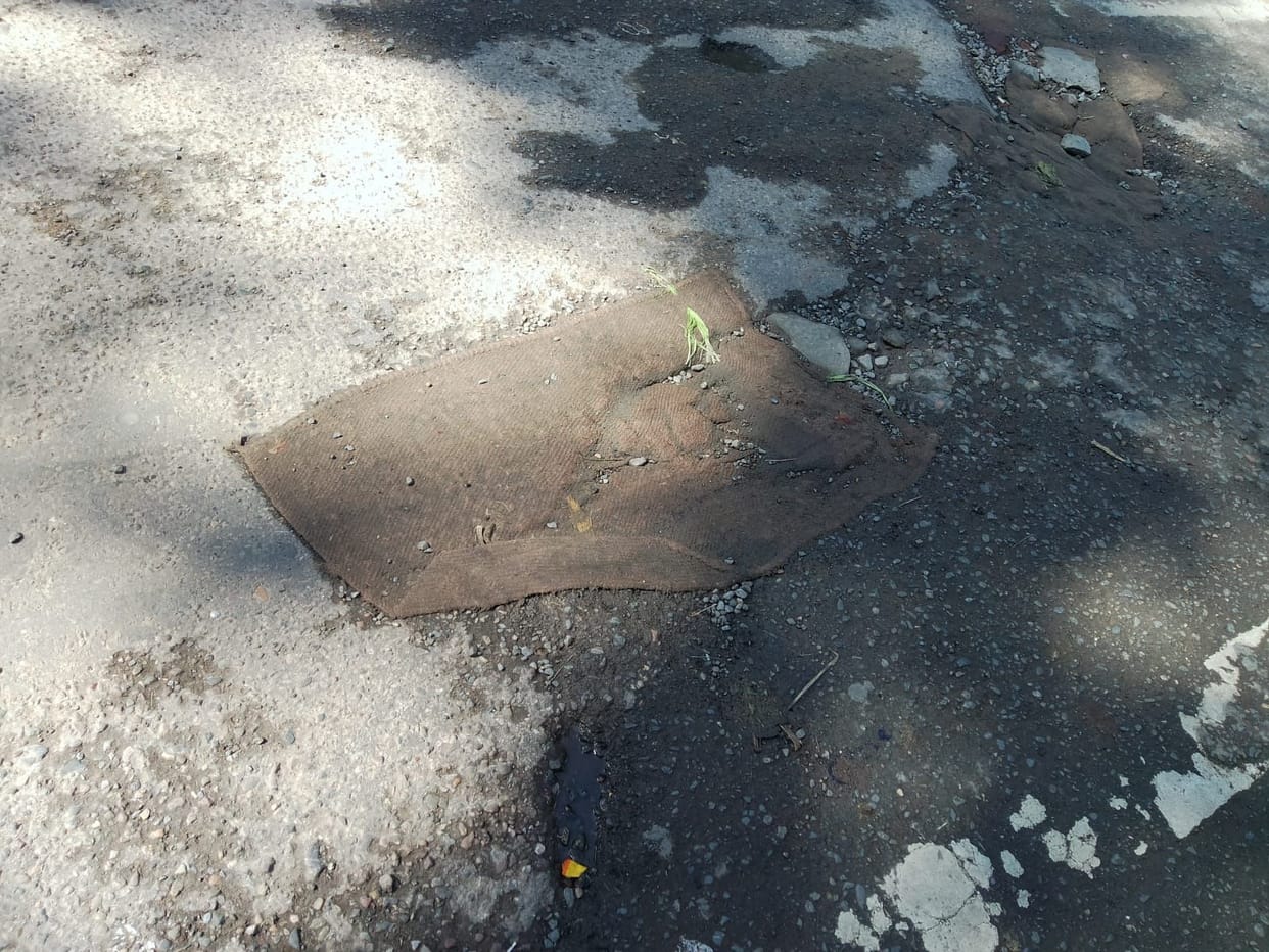 Instead of filling the potholes on the road, they covered them with sacks.