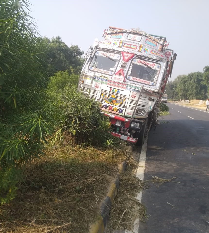 Truck hits DCM and runs over divider
