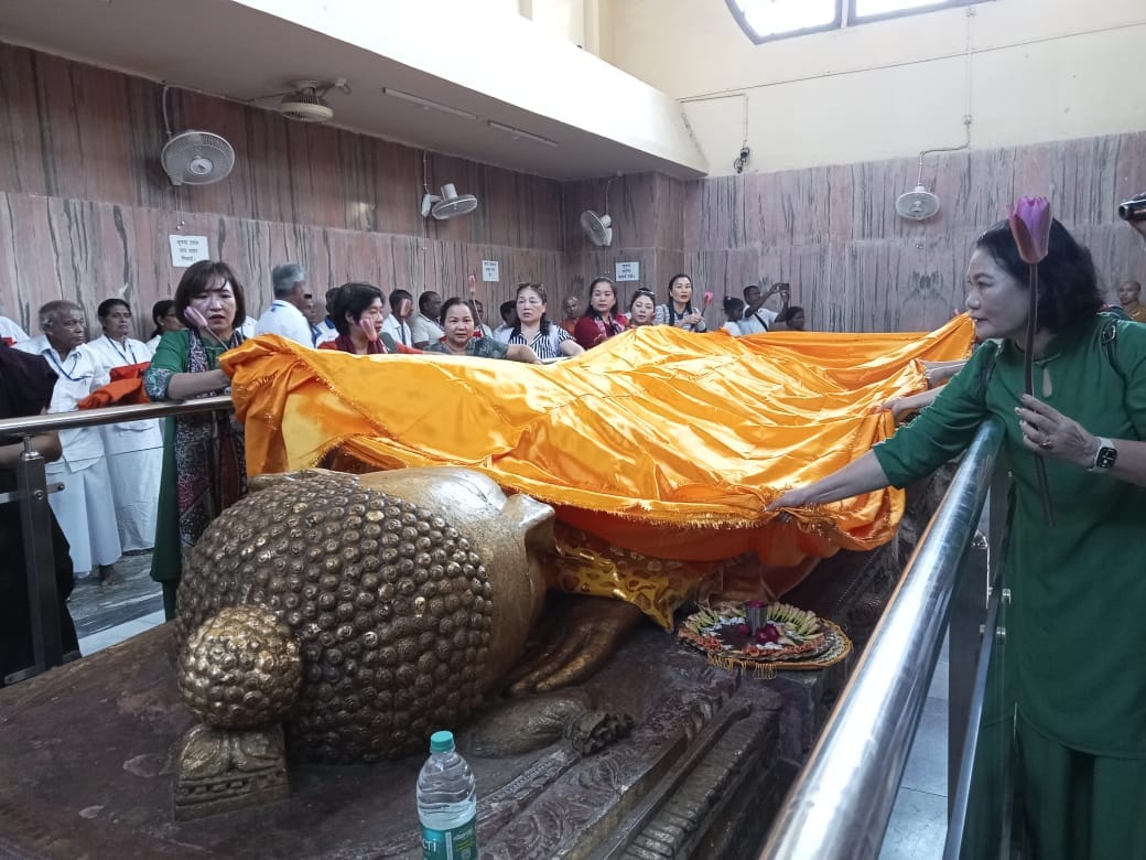 Foreign Buddhist followers offered robes to the statue of Mahatma Buddha