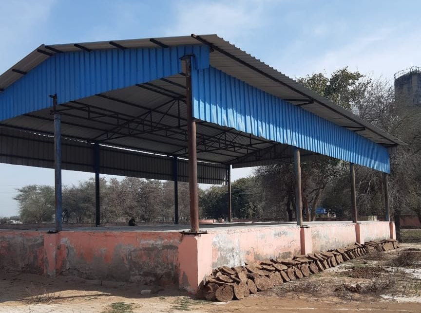 How will the villagers be cured by Yoga, when the gymnasium is being used for making cow dung cakes?