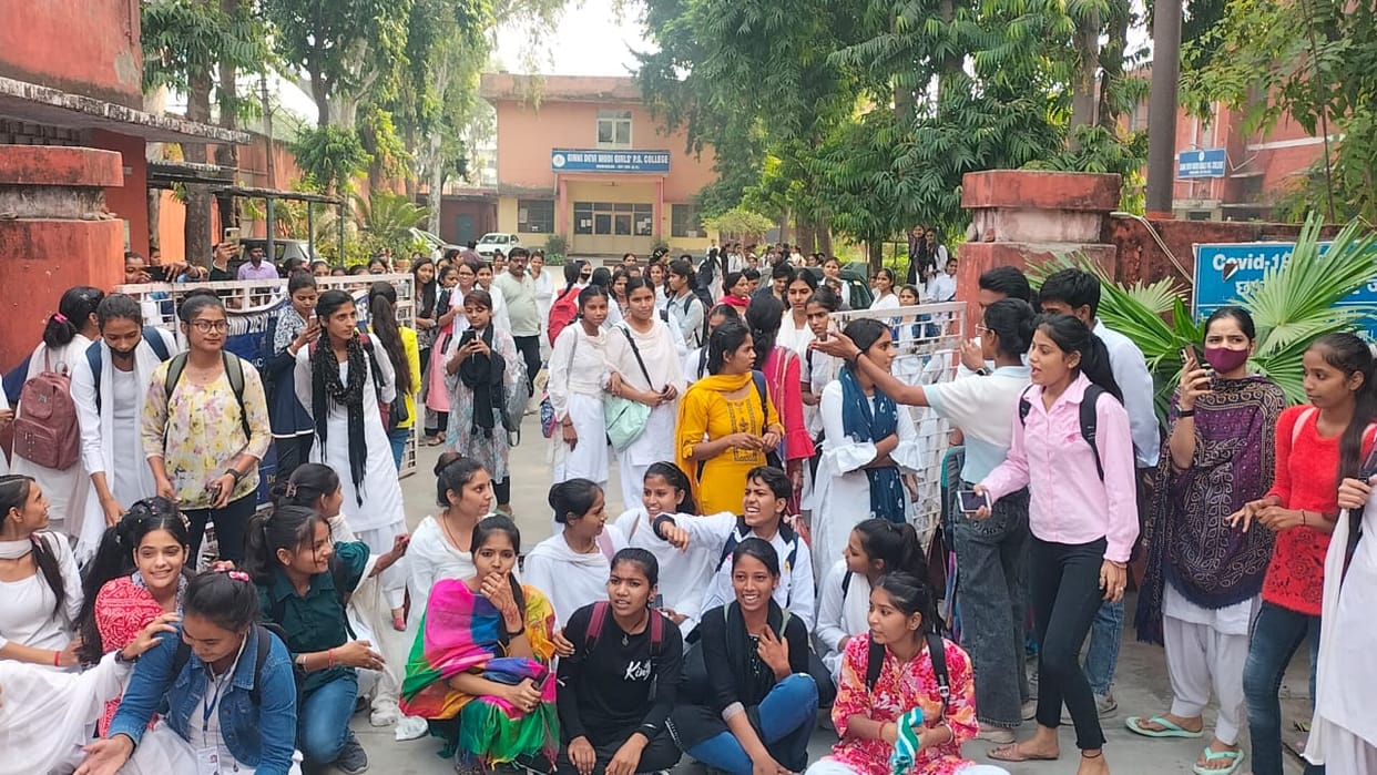 The girl students created a ruckus and surrounded the principal.