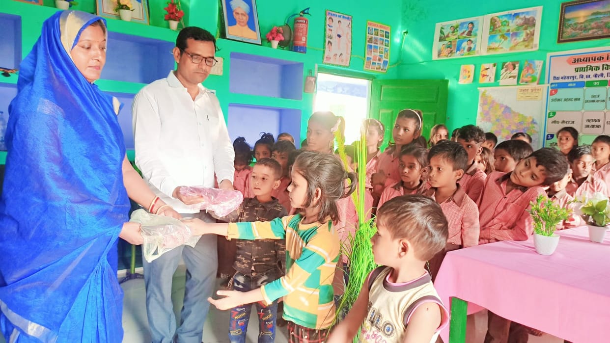 The headmaster distributed dresses to the children
