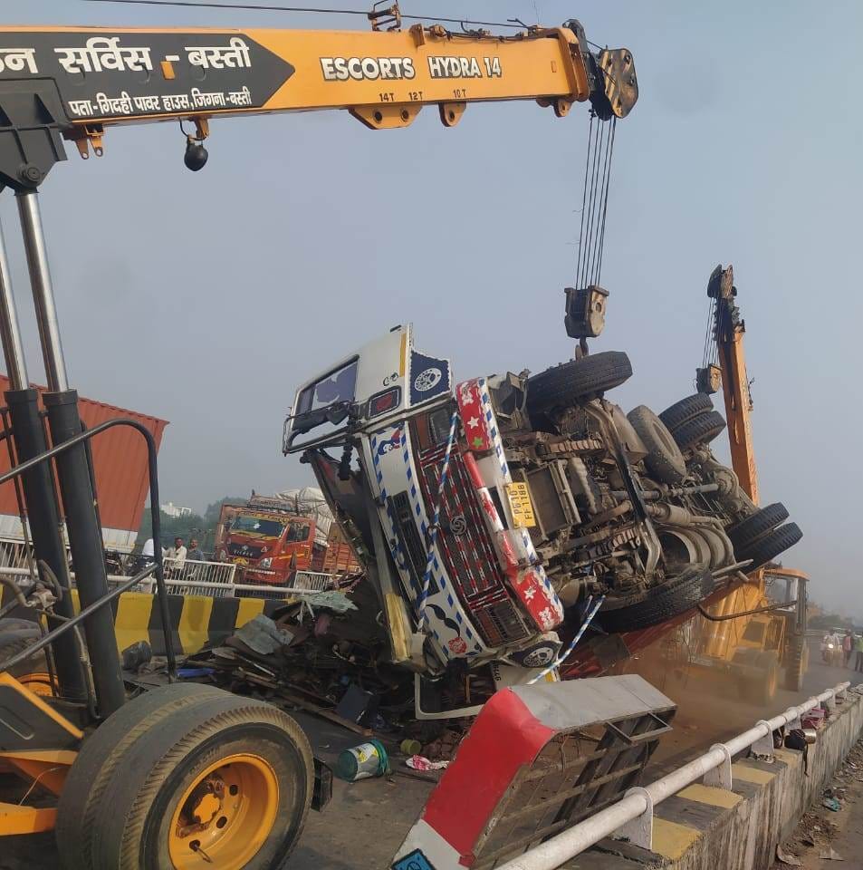 Truck loaded with junk overturned on four lane