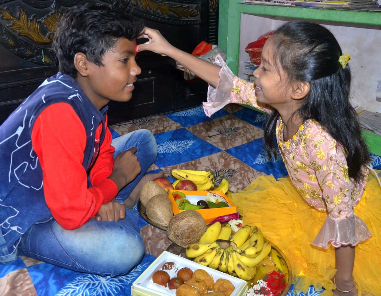 Bhaiya Dooj: Sisters pray for the long life of their brothers by applying tilak to them.