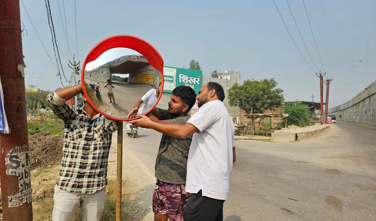 Social worker installed road safety convex mirror