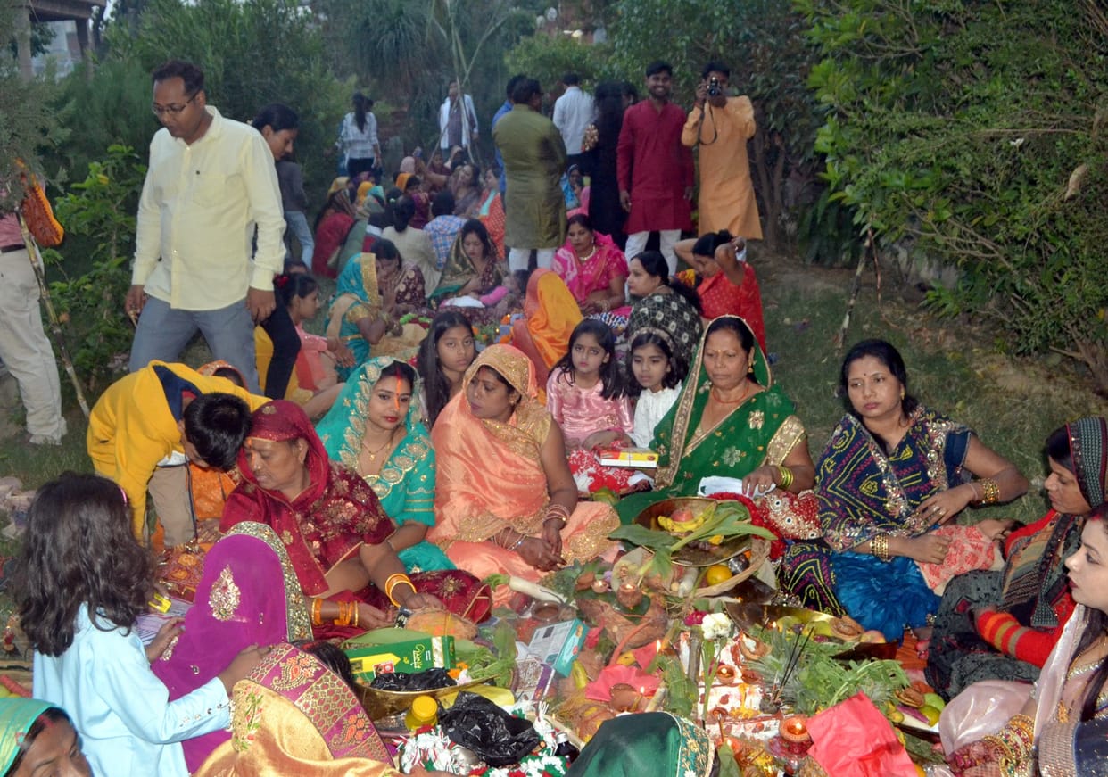 Devotees worshiped the setting Sun God by offering Arghya.