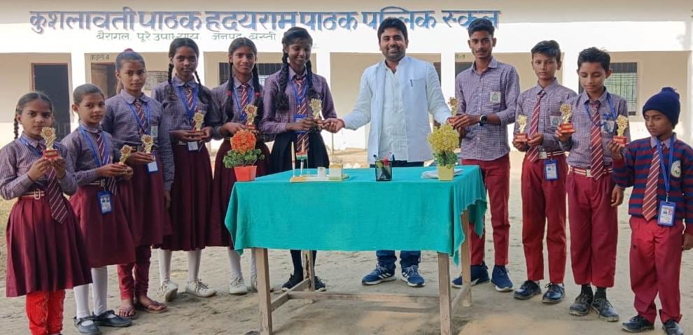 Manager rewarding the students of K P H R Public School Bairagal