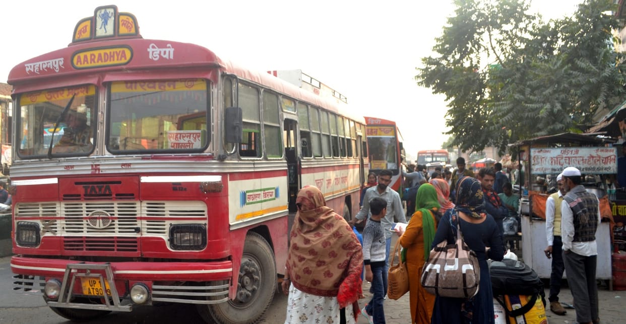 Roadways buses stand on the road, causing traffic jam