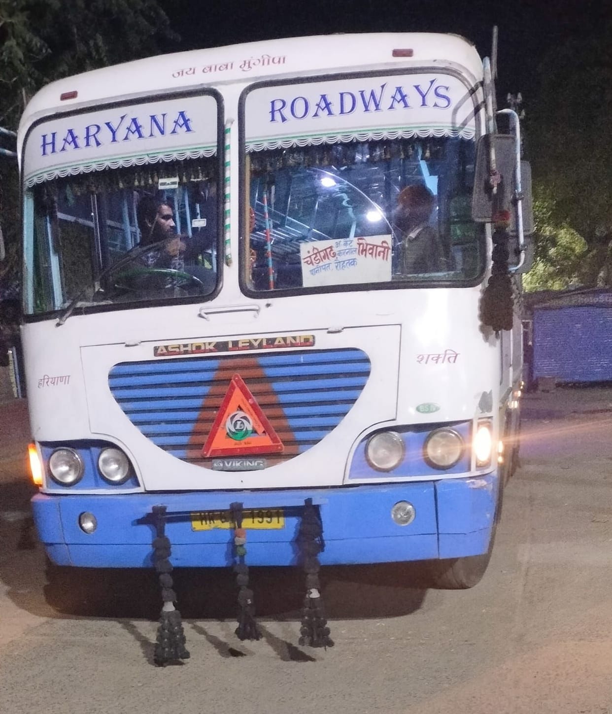 Smoke rises from the bonnet of the Kilometer Scheme moving bus, creating panic among the passengers