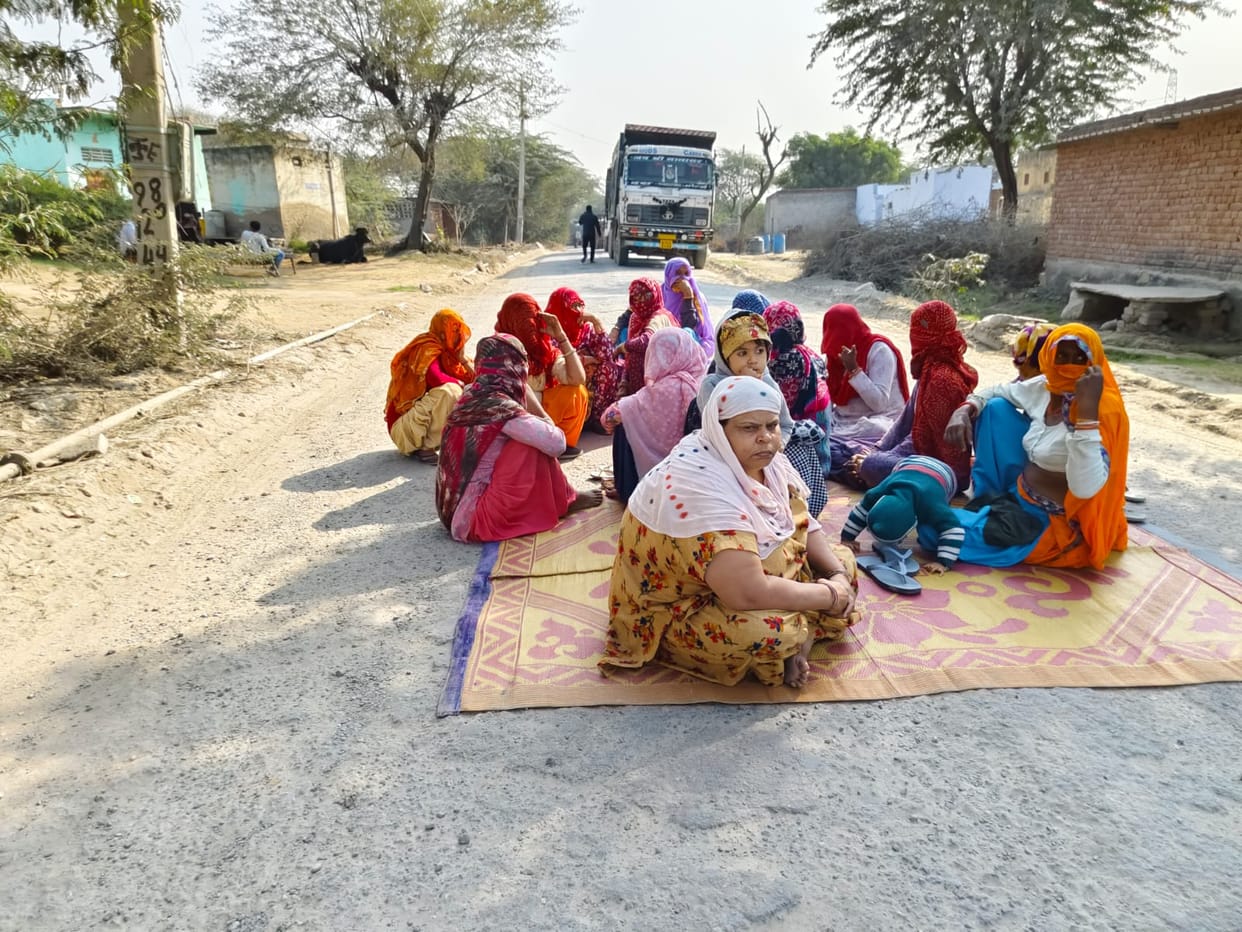 Women blocked the road in protest against overloaded dumper.