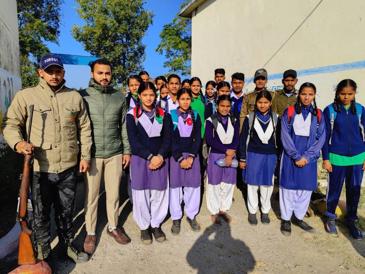 Forest personnel with guns took the children to school