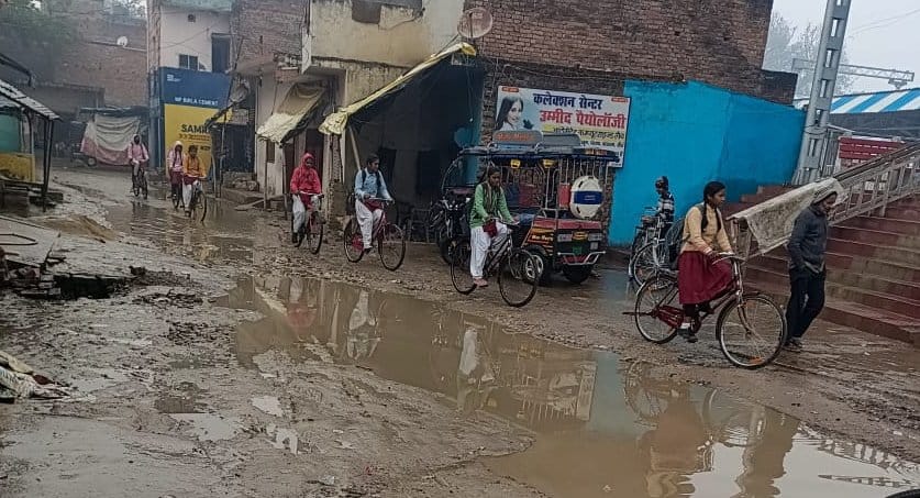 Road filled with water, pedestrians worried
