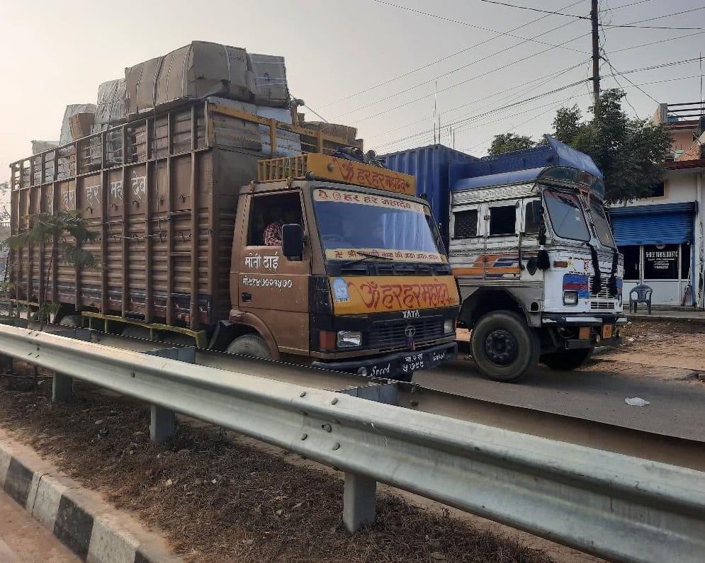 The overloaded vehicles are speeding by disregarding the rules.