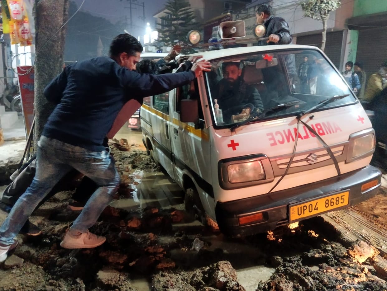 Ambulance wheel stuck in dug up pit