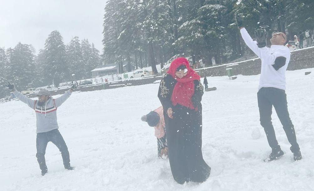 Tourists frolic in the snow in Khajjiar