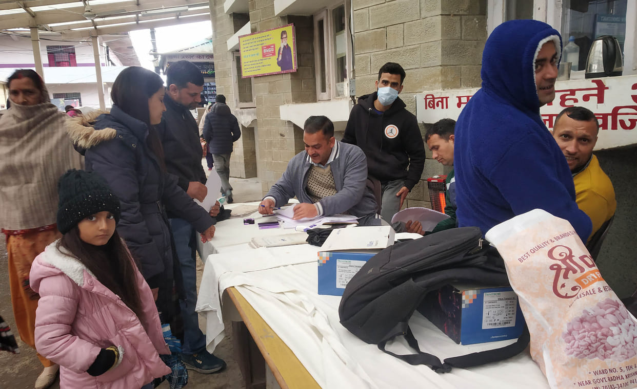 Patients are forced to get their slips cut in the cold wind under a tin roof.