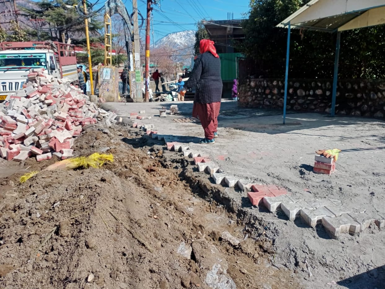 Municipal council laying paver tiles on footpath