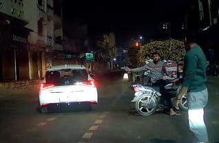 A youth riding a bike pointed a pistol at people riding a car.
