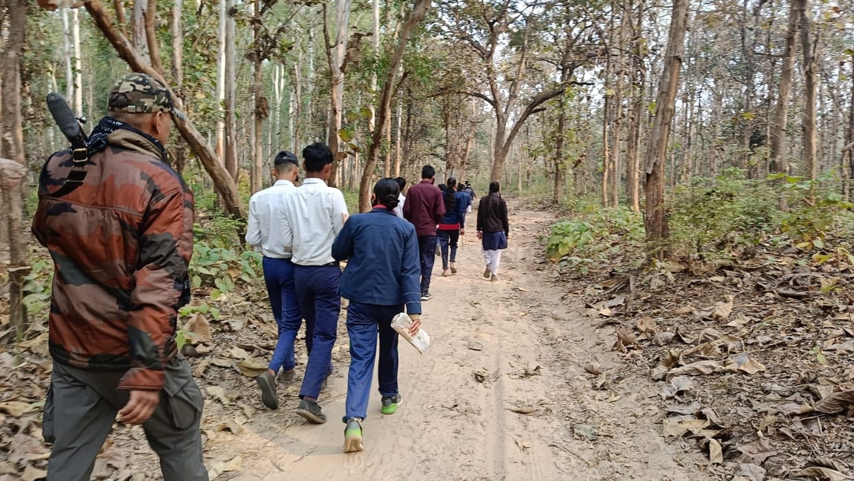Forest personnel with guns took the students to school
