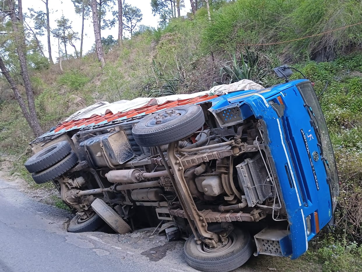 Truck overturns after tire sinks into roadside pit