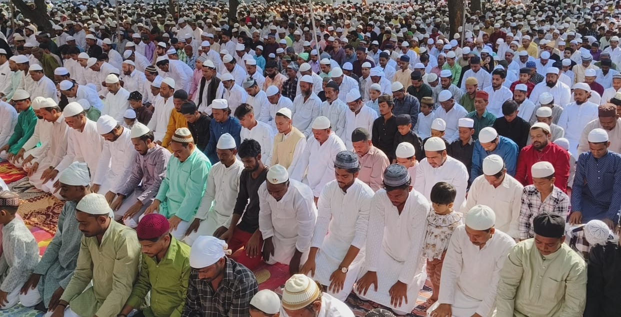 Raised hands for prayer, hugged and wished Eid Mubarak