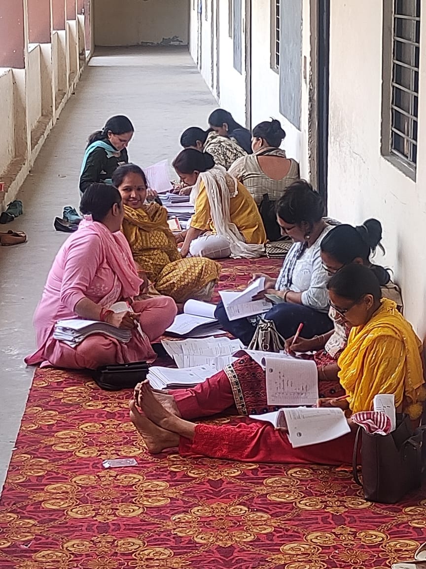 Teachers are marking 12th class sitting on carpet, no bench, no water to drink