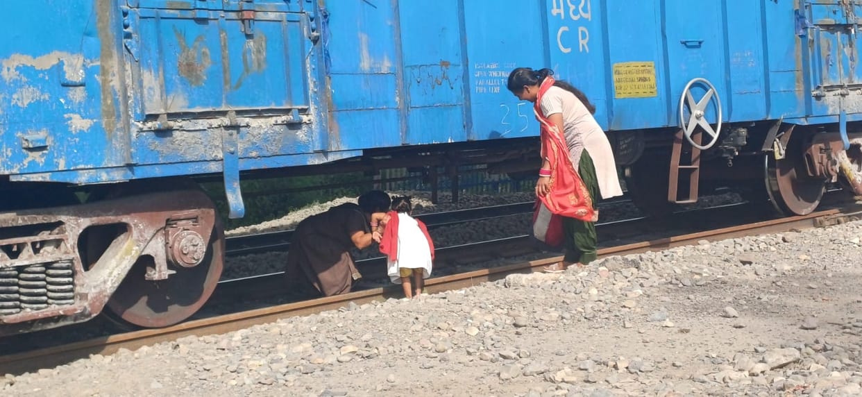 People getting out from under the freight train risking their lives