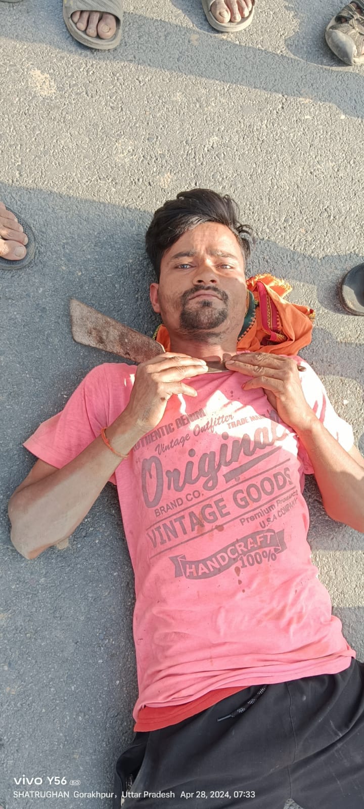When the police beat him, the youth lay down on the road with a sickle around his neck.