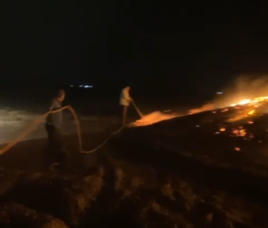 Fire in demolition pile during storm