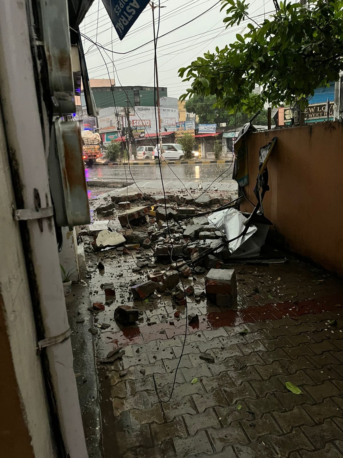 Sign board and wall bricks fell due to lightning